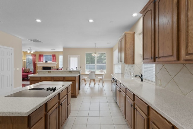 8105 Red Bird Ct, Austin, TX 78726 - kitchen with black electric stovetop, a kitchen island, decorative backsplash, open floor plan, and light countertops