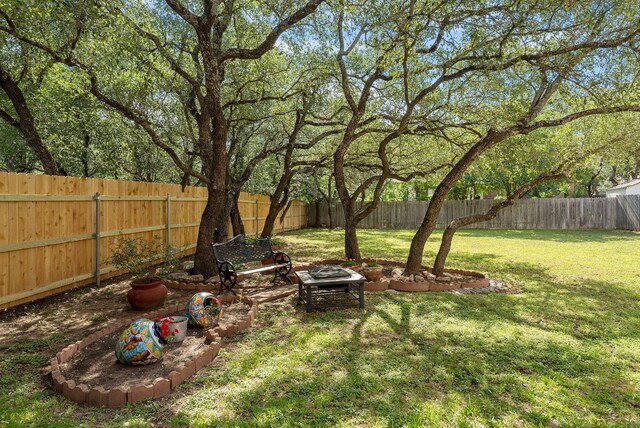 8105 Red Bird Ct, Austin, TX 78726 - fenced backyard with an outdoor fire pit