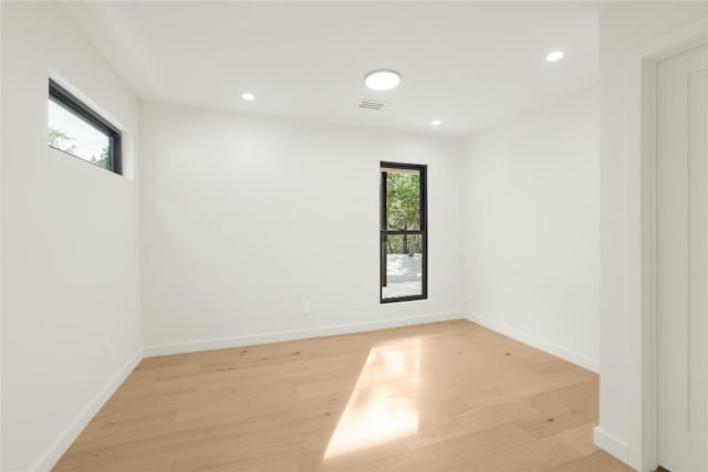 empty room featuring light wood-style flooring, recessed lighting, and baseboards