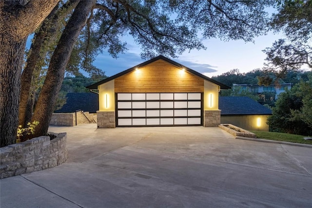 contemporary house with stone siding and a garage
