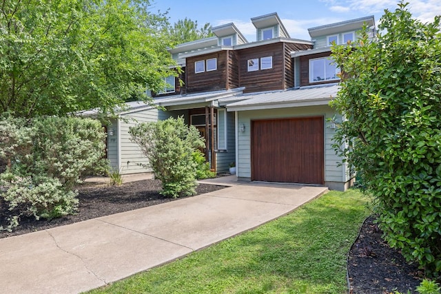 view of front of house featuring concrete driveway and a garage