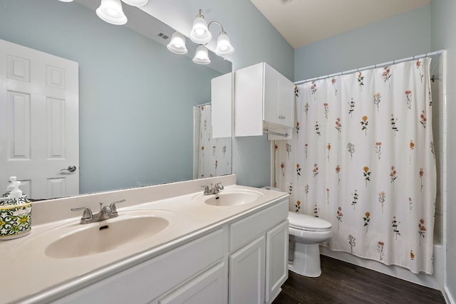 bathroom featuring wood finished floors, toilet, double vanity, and shower / bathtub combination with curtain
