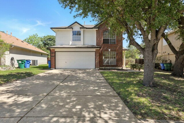2912 Sydney Dr, Austin, TX 78728 - traditional-style home featuring an attached garage, concrete driveway, and brick siding