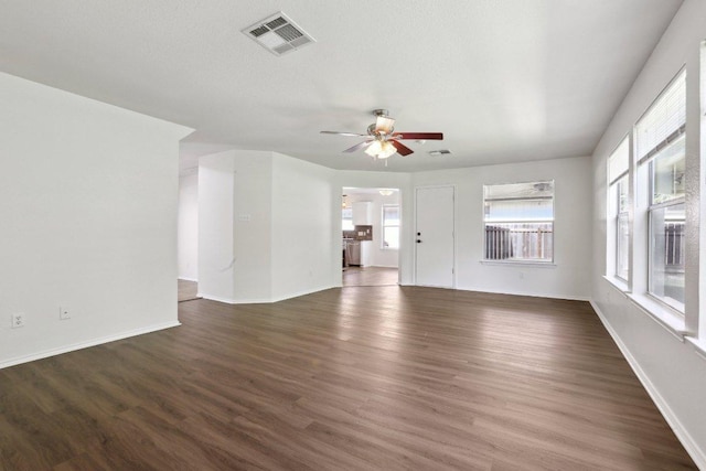 2912 Sydney Dr, Austin, TX 78728 - unfurnished living room with ceiling fan, wood finished floors, and baseboards