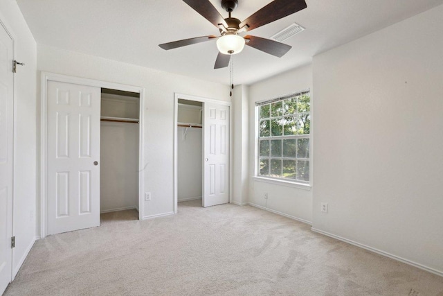 2912 Sydney Dr, Austin, TX 78728 - unfurnished bedroom featuring multiple closets, carpet flooring, baseboards, and ceiling fan