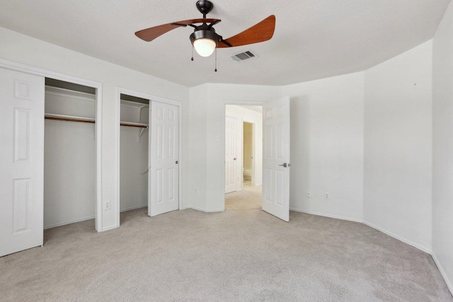 2912 Sydney Dr, Austin, TX 78728 - unfurnished bedroom with two closets, light colored carpet, and ceiling fan
