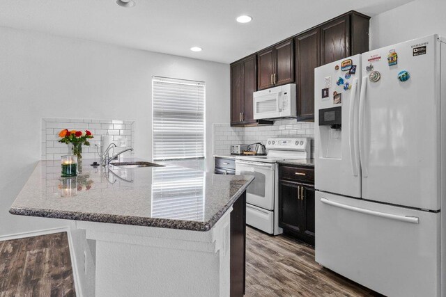 607 Big Bend Trl, Taylor, TX 76574 - kitchen with white appliances, dark brown cabinets, stone counters, wood finished floors, and a sink