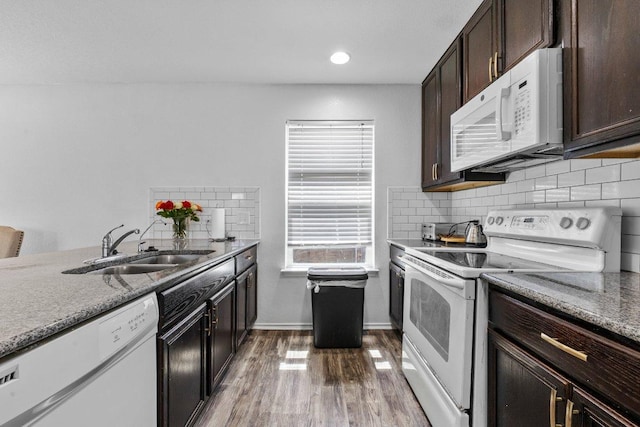 607 Big Bend Trl, Taylor, TX 76574 - kitchen featuring white appliances, a sink, decorative backsplash, wood finished floors, and dark brown cabinets