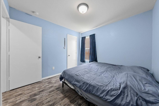607 Big Bend Trl, Taylor, TX 76574 - bedroom with wood finished floors and baseboards