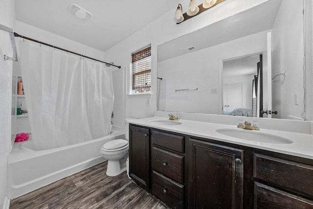 607 Big Bend Trl, Taylor, TX 76574 - full bath with double vanity, shower / tub combo with curtain, wood finished floors, and toilet