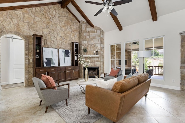 living room with ceiling fan, a fireplace, and baseboards
