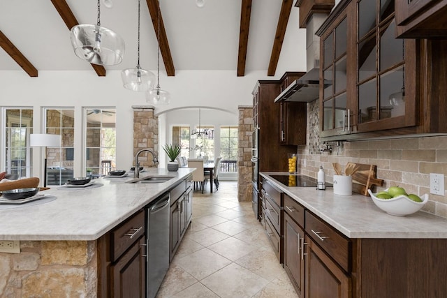 kitchen featuring a sink, a chandelier, tasteful backsplash, arched walkways, and glass insert cabinets