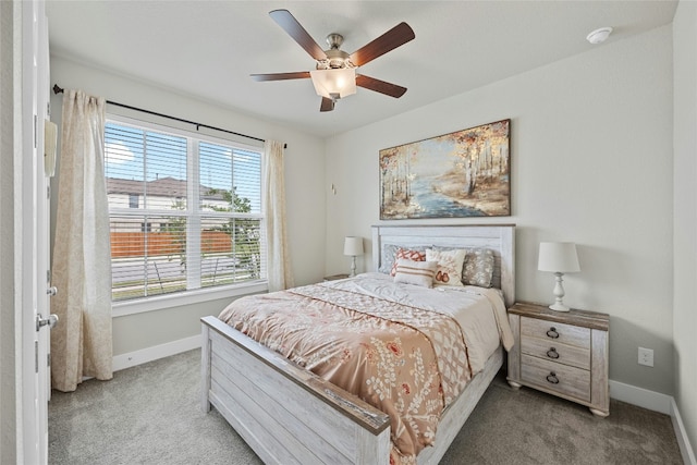bedroom with light colored carpet, baseboards, and ceiling fan