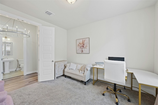 home office with a chandelier, baseboards, and carpet