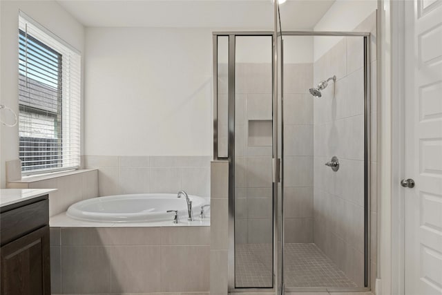 bathroom featuring vanity, a garden tub, and a stall shower