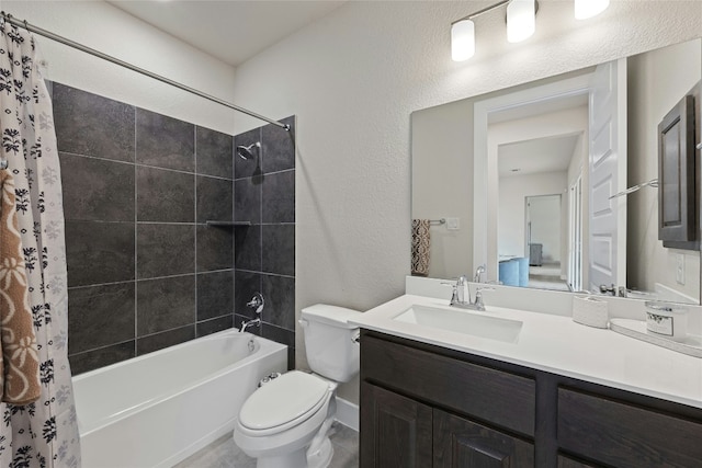 full bathroom with toilet, shower / tub combo, vanity, and a textured wall