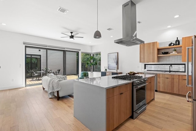 2003 Karen Ave Unit A, Austin, TX 78757 - kitchen featuring island range hood, gas stove, modern cabinets, light wood-style flooring, and open shelves