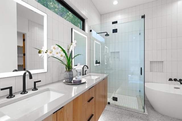 2003 Karen Ave Unit A, Austin, TX 78757 - full bath featuring tile walls, speckle patterned floor, a shower stall, double vanity, and a freestanding bath