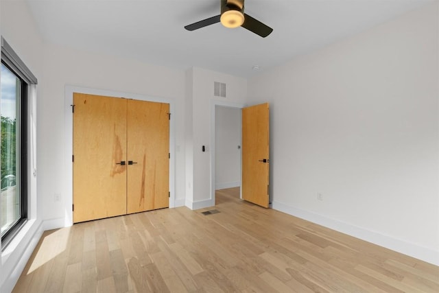 2003 Karen Ave Unit A, Austin, TX 78757 - unfurnished bedroom with light wood-type flooring, multiple windows, baseboards, and a closet