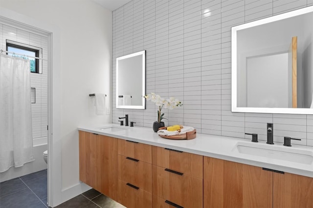 2003 Karen Ave Unit A, Austin, TX 78757 - bathroom featuring double vanity, tile patterned flooring, toilet, decorative backsplash, and shower / tub combo