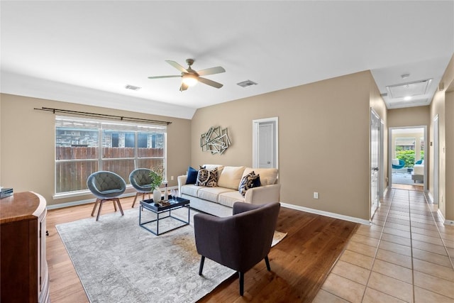 2415 Arbor Dr, Round Rock, TX 78681 - living room featuring ceiling fan, light wood finished floors, baseboards, and attic access