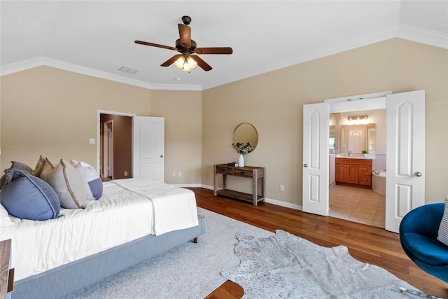 2415 Arbor Dr, Round Rock, TX 78681 - bedroom with vaulted ceiling, light wood-style floors, ornamental molding, baseboards, and ensuite bathroom