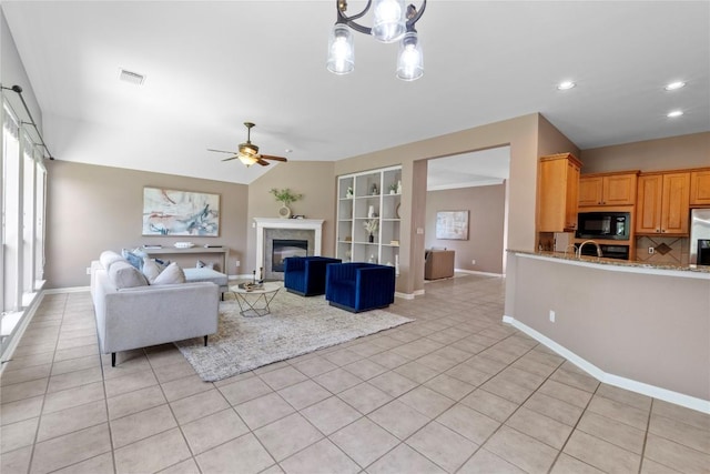 2415 Arbor Dr, Round Rock, TX 78681 - living room with light tile patterned flooring, ceiling fan, baseboards, a glass covered fireplace, and recessed lighting