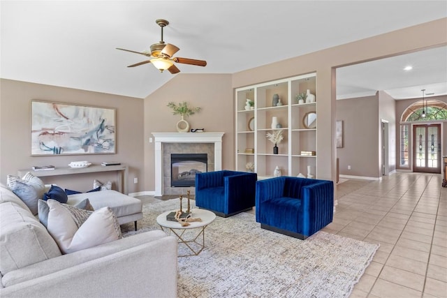 2415 Arbor Dr, Round Rock, TX 78681 - tiled living room featuring baseboards, a ceiling fan, a tile fireplace, and vaulted ceiling