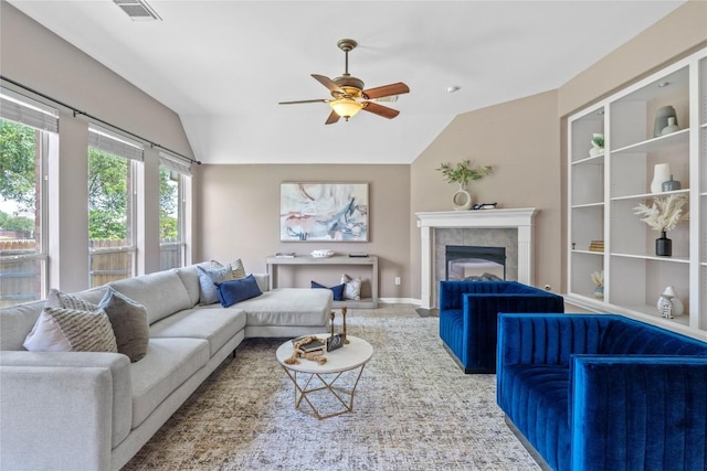 2415 Arbor Dr, Round Rock, TX 78681 - living area with vaulted ceiling, a ceiling fan, a tiled fireplace, and baseboards