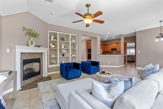 2415 Arbor Dr, Round Rock, TX 78681 - living area with light tile patterned flooring, ceiling fan, a tiled fireplace, recessed lighting, and baseboards