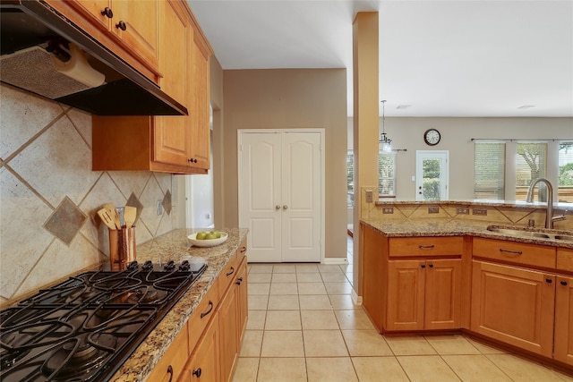 2415 Arbor Dr, Round Rock, TX 78681 - kitchen featuring a sink, under cabinet range hood, black gas cooktop, decorative backsplash, and light stone counters