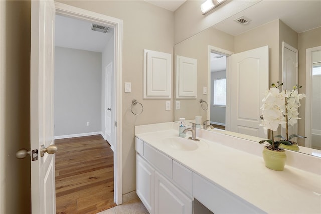 2415 Arbor Dr, Round Rock, TX 78681 - bathroom with vanity, wood finished floors, and baseboards