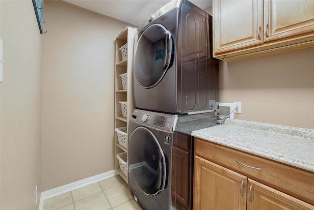 2415 Arbor Dr, Round Rock, TX 78681 - washroom featuring stacked washing machine and dryer, cabinet space, baseboards, and light tile patterned flooring