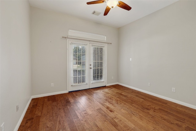 2415 Arbor Dr, Round Rock, TX 78681 - spare room featuring french doors, a ceiling fan, wood finished floors, and baseboards