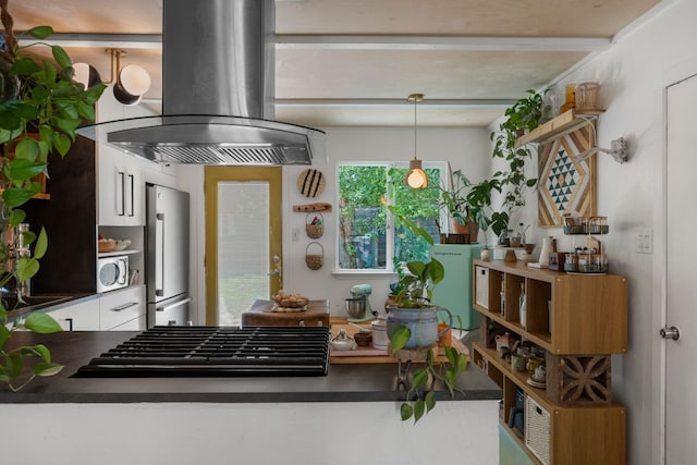 1644 Chippeway Ln, Austin, TX 78745 - kitchen with island range hood, stainless steel appliances, white cabinets, dark countertops, and open shelves