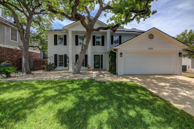 6018 Abilene Trl, Austin, TX 78749 - neoclassical / greek revival house with concrete driveway, brick siding, and a garage