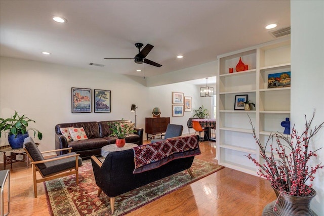 6018 Abilene Trl, Austin, TX 78749 - living area with wood finished floors, a ceiling fan, recessed lighting, and a chandelier