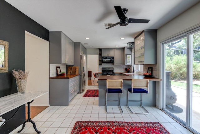 6018 Abilene Trl, Austin, TX 78749 - kitchen with black appliances, gray cabinets, a sink, ceiling fan, and tasteful backsplash