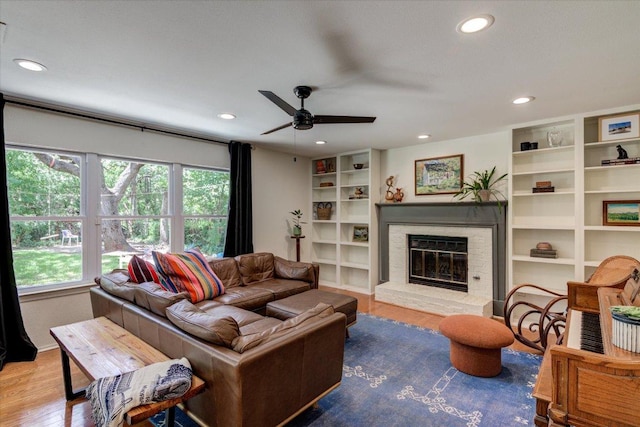 6018 Abilene Trl, Austin, TX 78749 - living area featuring recessed lighting, a glass covered fireplace, wood finished floors, and a ceiling fan