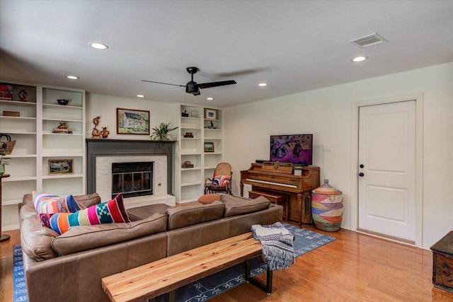 6018 Abilene Trl, Austin, TX 78749 - living room with ceiling fan, wood finished floors, recessed lighting, and a glass covered fireplace