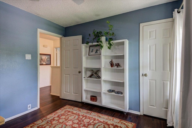 6018 Abilene Trl, Austin, TX 78749 - bedroom with dark wood-style floors, baseboards, and a textured ceiling