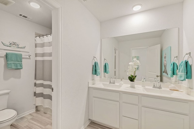 4418 Royal Oak Blvd, San Marcos, TX 78666 - full bath with toilet, baseboards, double vanity, a shower with curtain, and wood finished floors