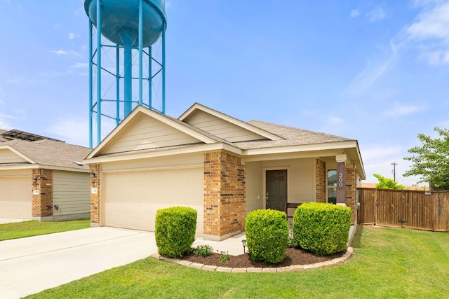 200 Circle Way Unit 8E, Jarrell, TX 76537 - view of front facade with brick siding, a garage, driveway, and roof with shingles