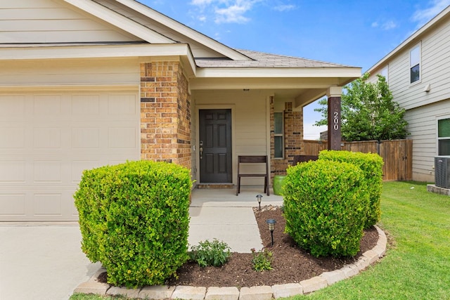 200 Circle Way Unit 8E, Jarrell, TX 76537 - view of exterior entry with brick siding, a garage, and a porch