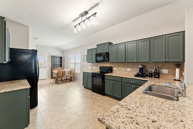 200 Circle Way Unit 8E, Jarrell, TX 76537 - kitchen with black appliances, a sink, green cabinetry, lofted ceiling, and tasteful backsplash