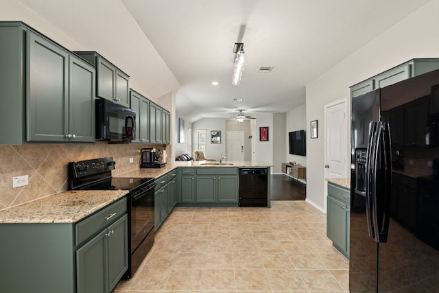 200 Circle Way Unit 8E, Jarrell, TX 76537 - kitchen featuring black appliances, green cabinetry, a peninsula, and vaulted ceiling