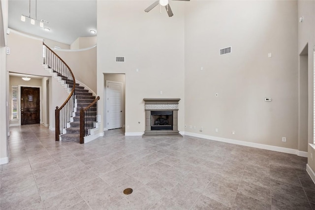 2713 Margarita Ct, Round Rock, TX 78665 - unfurnished living room with a high ceiling, ceiling fan, baseboards, stairs, and light tile patterned floors