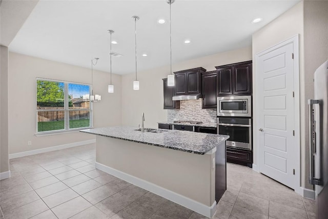 2713 Margarita Ct, Round Rock, TX 78665 - kitchen featuring stainless steel appliances, a sink, light stone counters, tasteful backsplash, and light tile patterned floors