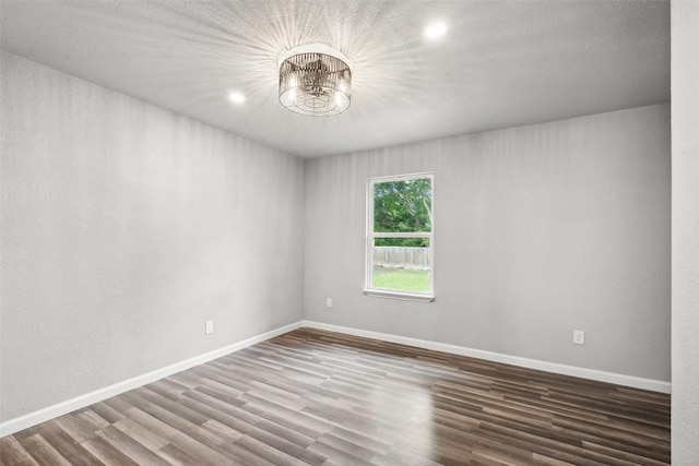 7000 Carwill Dr, Austin, TX 78724 - spare room with a chandelier, wood finished floors, baseboards, and recessed lighting