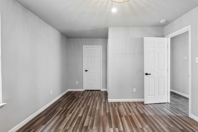 7000 Carwill Dr, Austin, TX 78724 - unfurnished bedroom featuring dark wood-type flooring and baseboards